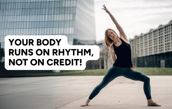 Woman in a yoga pose outdoors in front of modern buildings with a bold text overlay that reads “Your body runs on rhythm, not on credit!”—emphasizing the importance of consistent recovery over weekend sleep catch-up.