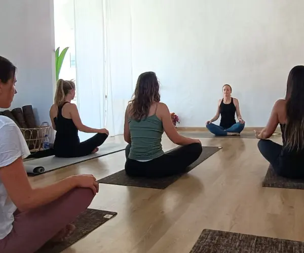 Small group yoga class in Lisbon studio with guided meditation